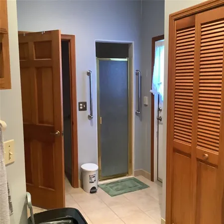 a bedroom with a bed and a flat tv screen on dresser