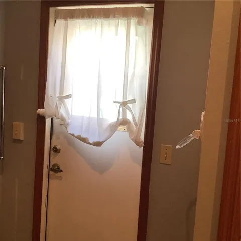 a bedroom with a bed and a flat tv screen on dresser