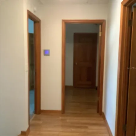 a view of an entryway with wooden floor