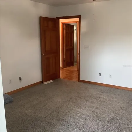 a view of bedroom with a bed and a chair