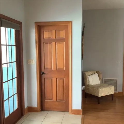a bedroom with a bed and chandelier