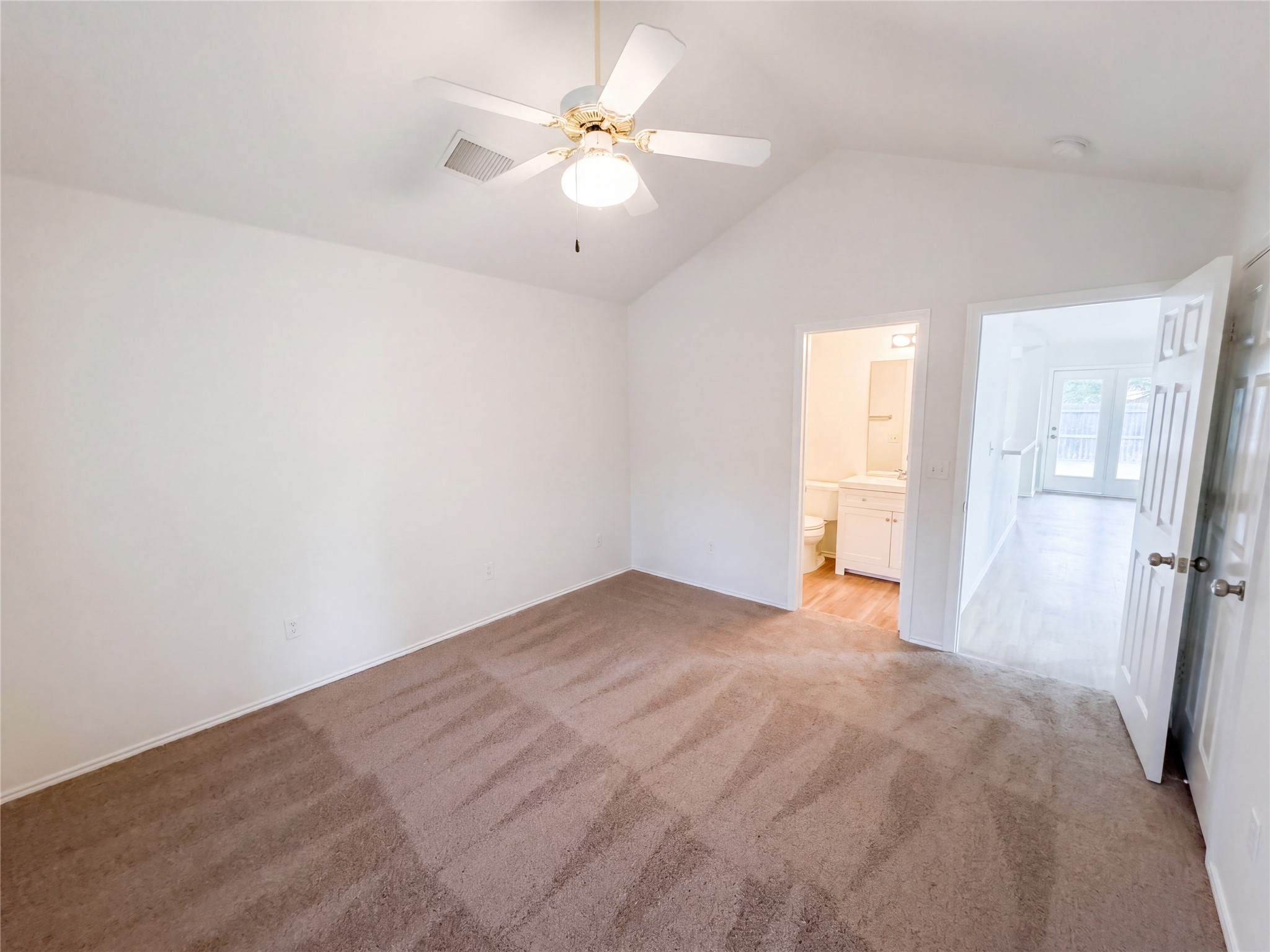 172 Prairie Springs Loop Georgetown, TX 78626 - Photo 20 of 32 Vaulted ceilings and plush carpeting define this serene bedroom space with an attached bath.