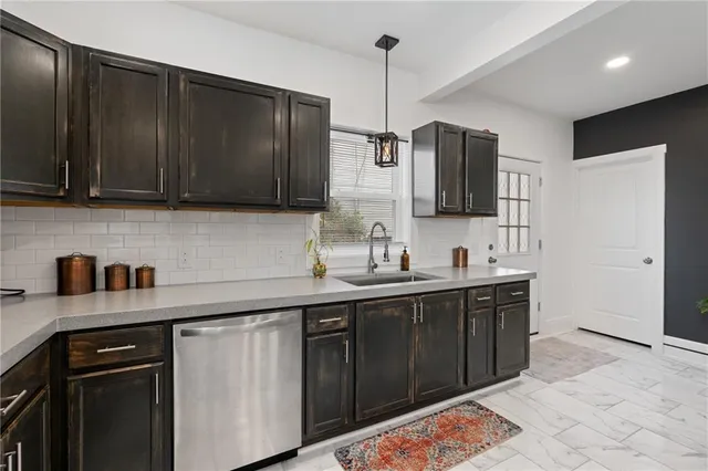 a kitchen with stainless steel appliances kitchen island granite countertop a sink stove and cabinets