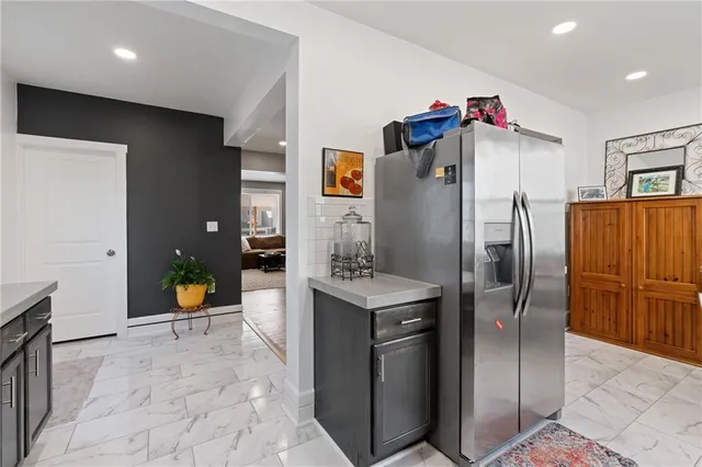 a view of a kitchen with a refrigerator and a sink
