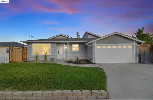 a front view of a house with a yard and garage