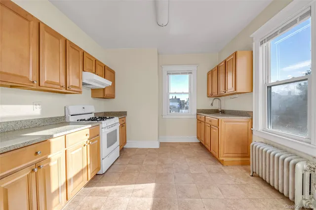 a kitchen with a sink stove and cabinets