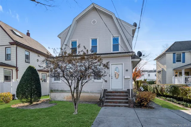 a front view of a house with a garden