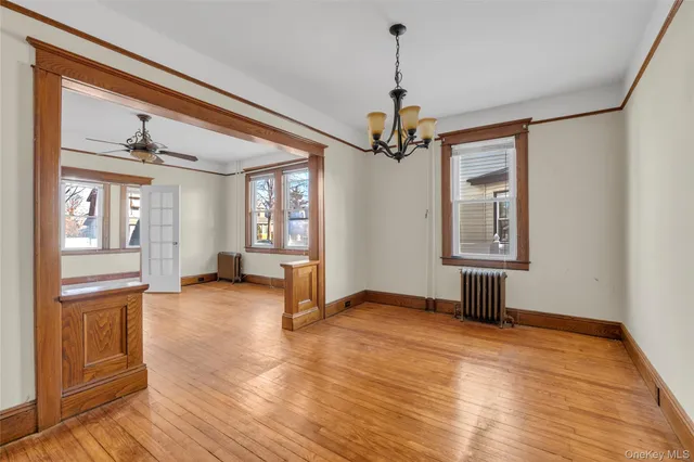 a view of a livingroom with a chandelier furniture and windows