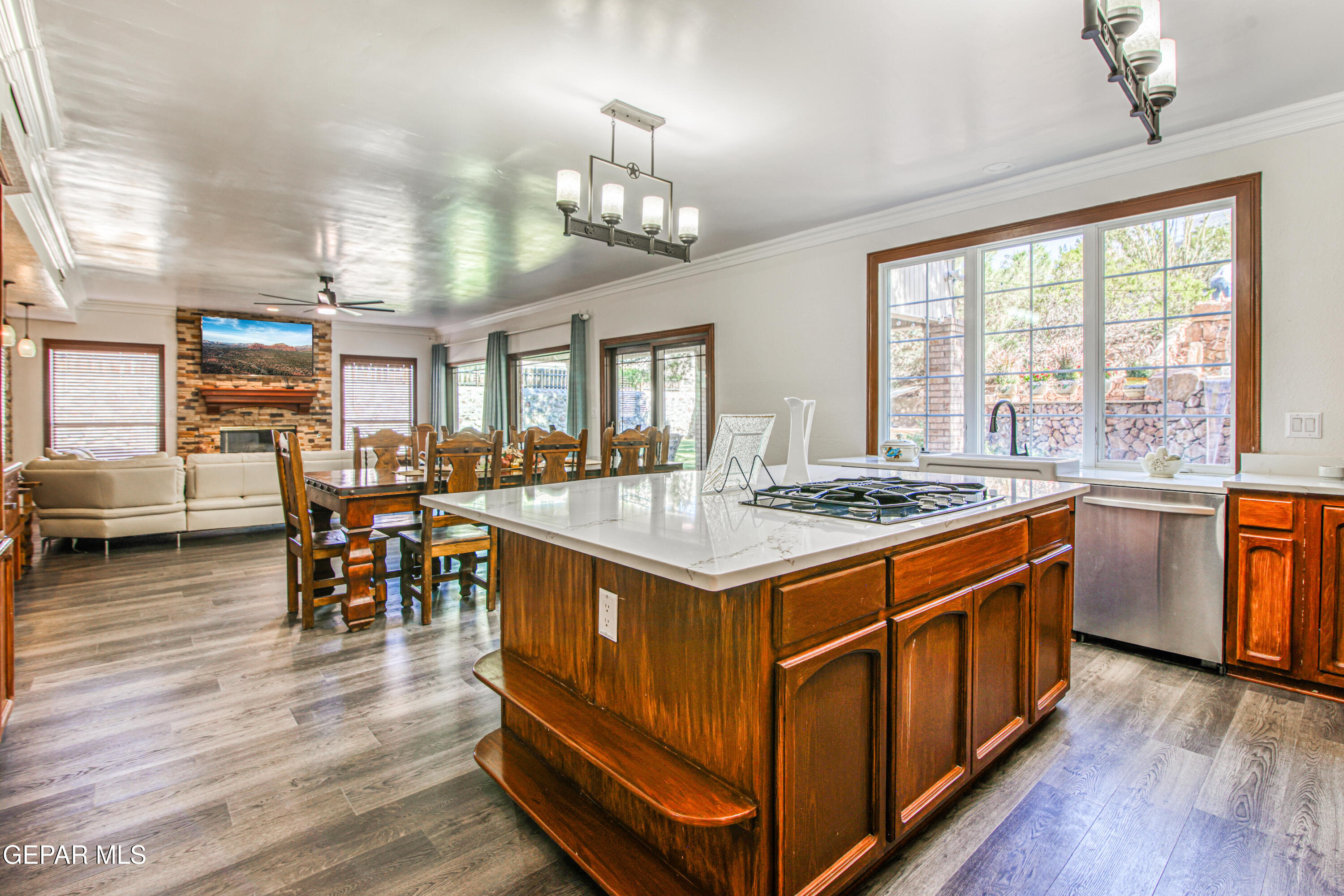 6620 Imperial Ridge Drive El Paso, TX 79912 - Photo 13 of 50 a kitchen with stainless steel appliances granite countertop a stove and wooden floor