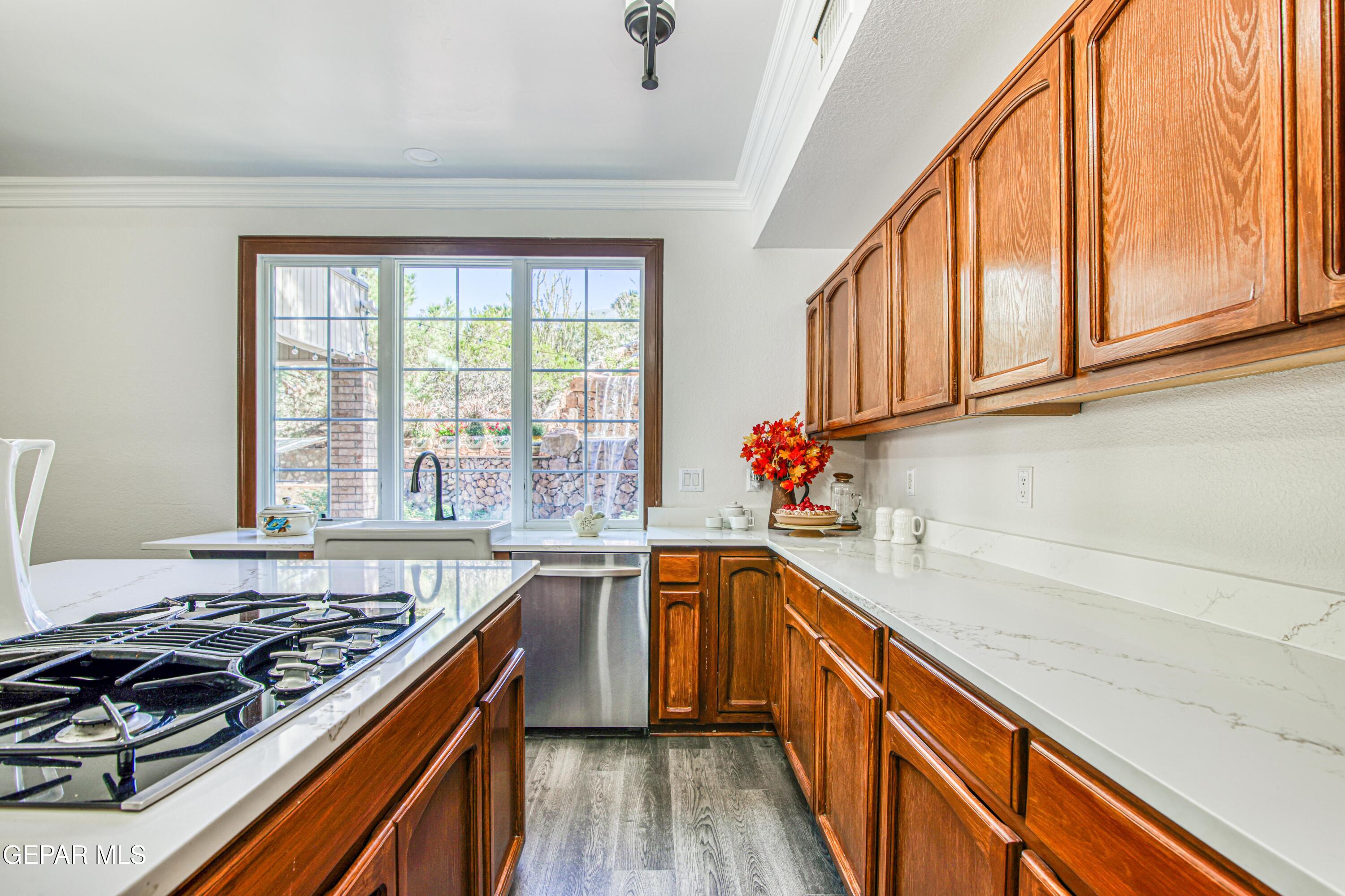 6620 Imperial Ridge Drive El Paso, TX 79912 - Photo 14 of 50 a kitchen with stainless steel appliances granite countertop a sink and a stove