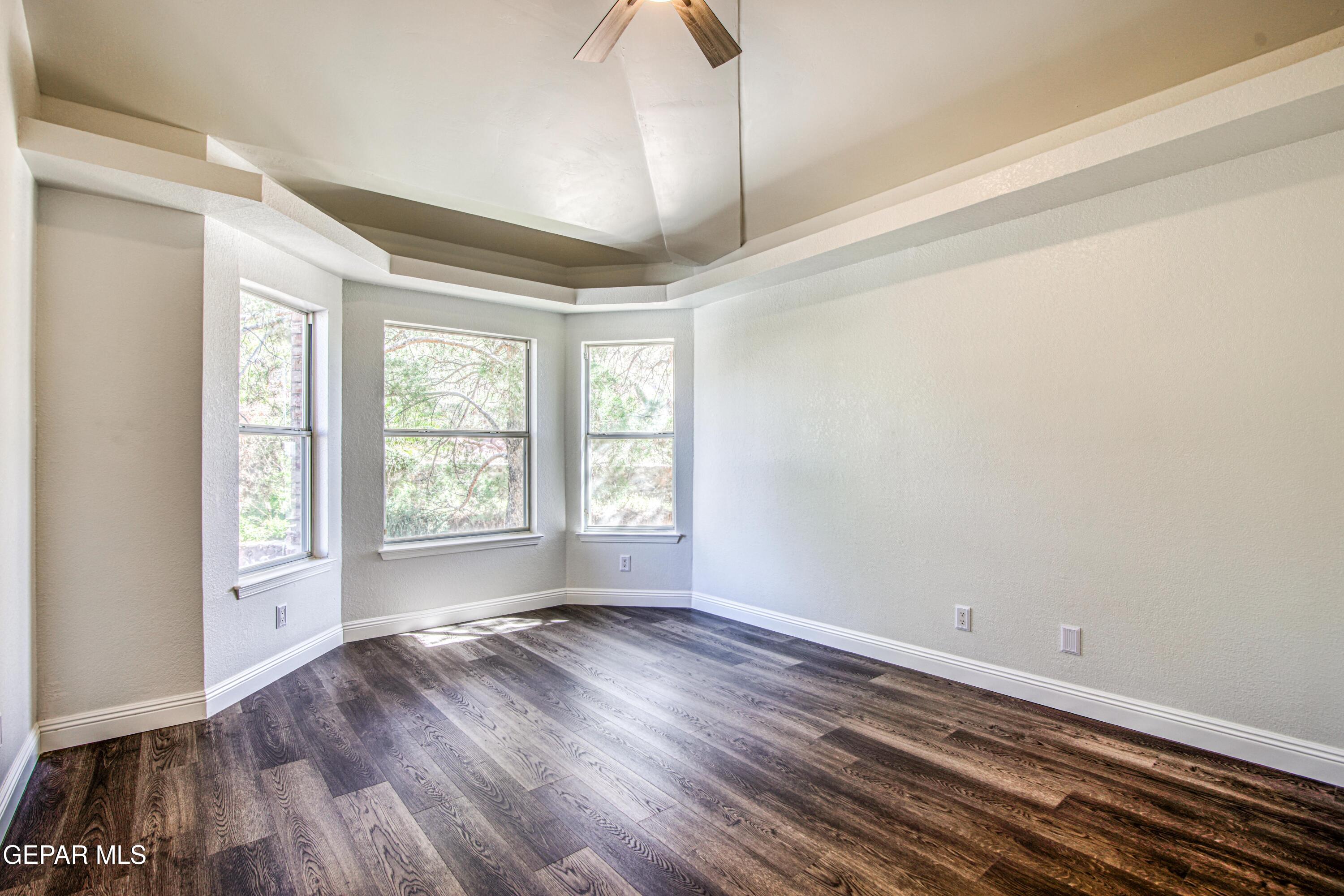 6620 Imperial Ridge Drive El Paso, TX 79912 - Photo 25 of 50 wooden floor in an empty room with a window