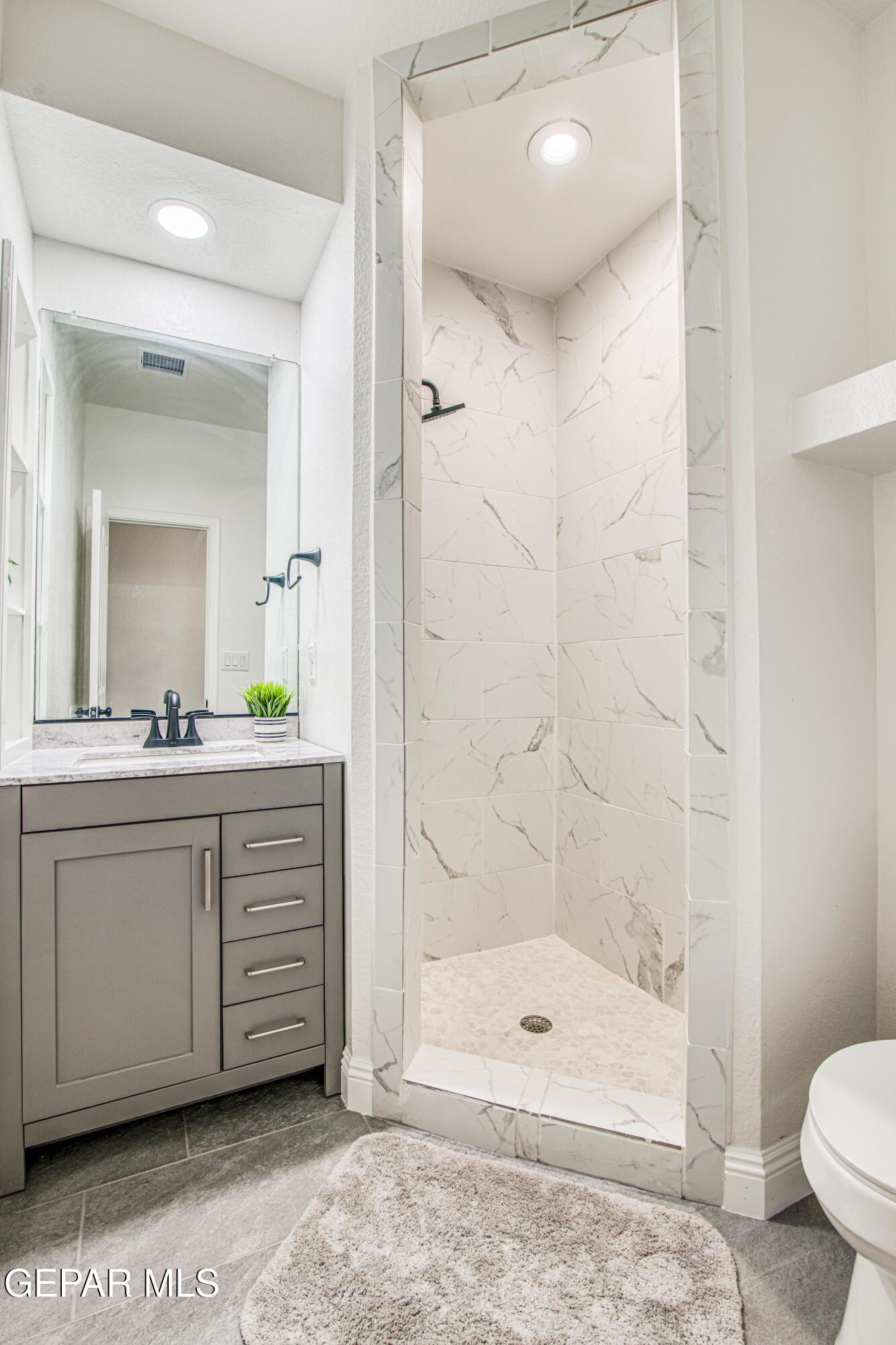 6620 Imperial Ridge Drive El Paso, TX 79912 - Photo 36 of 50 a bathroom with a double vanity sink toilet and shower