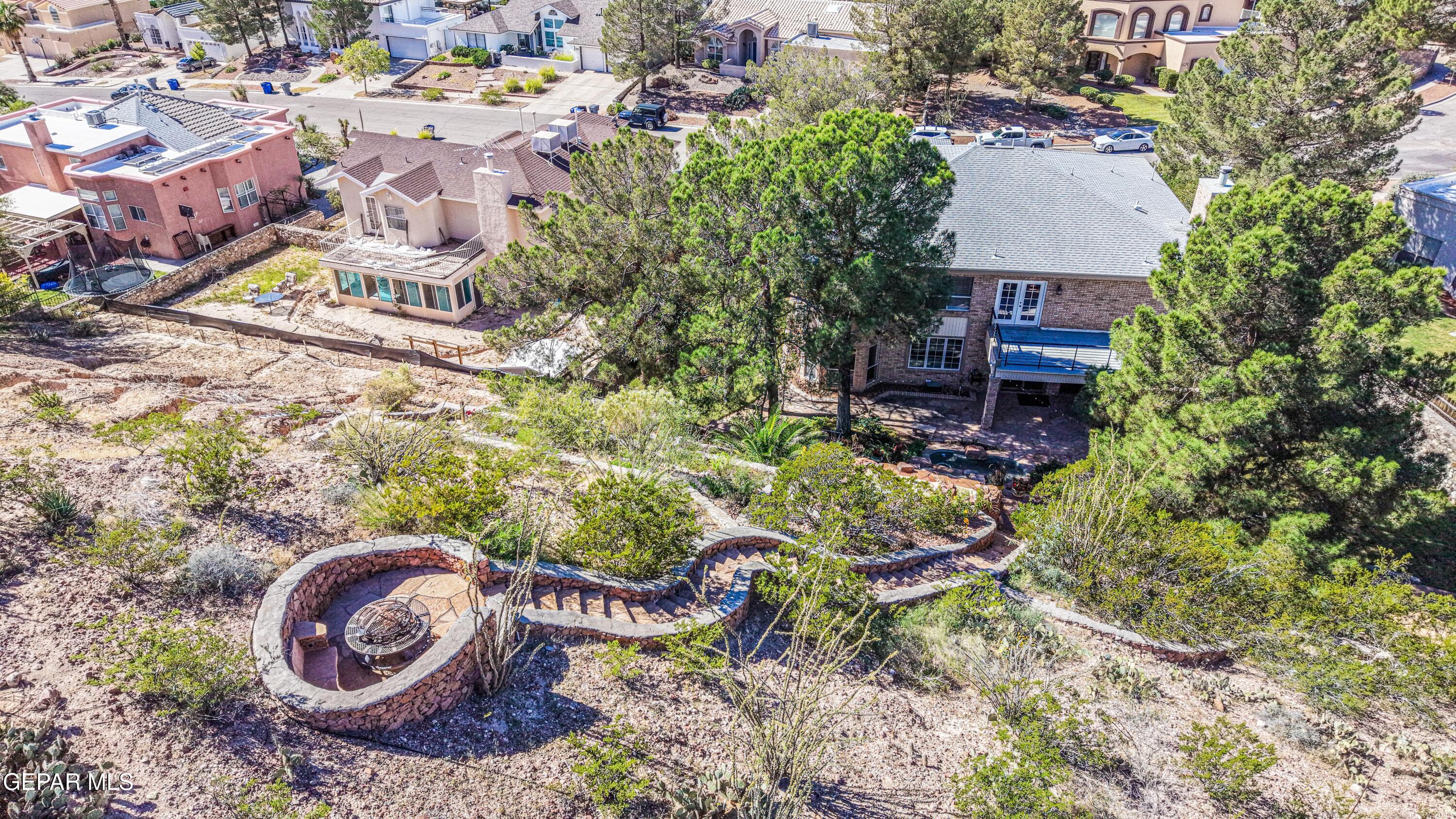 6620 Imperial Ridge Drive El Paso, TX 79912 - Photo 45 of 50 an aerial view of a house with a yard and large trees