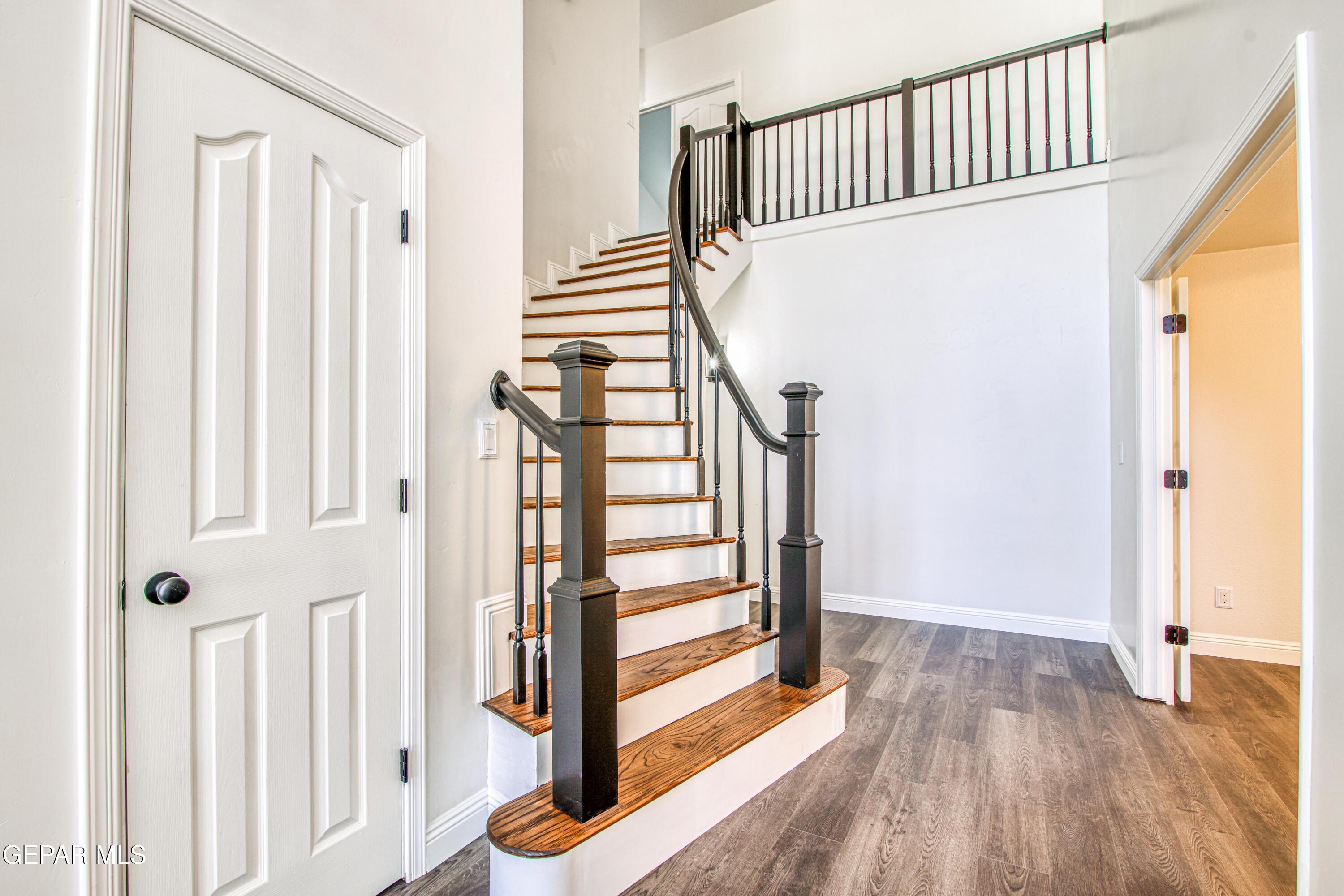6620 Imperial Ridge Drive El Paso, TX 79912 - Photo 7 of 50 a view of a hallway with wooden floor and staircase