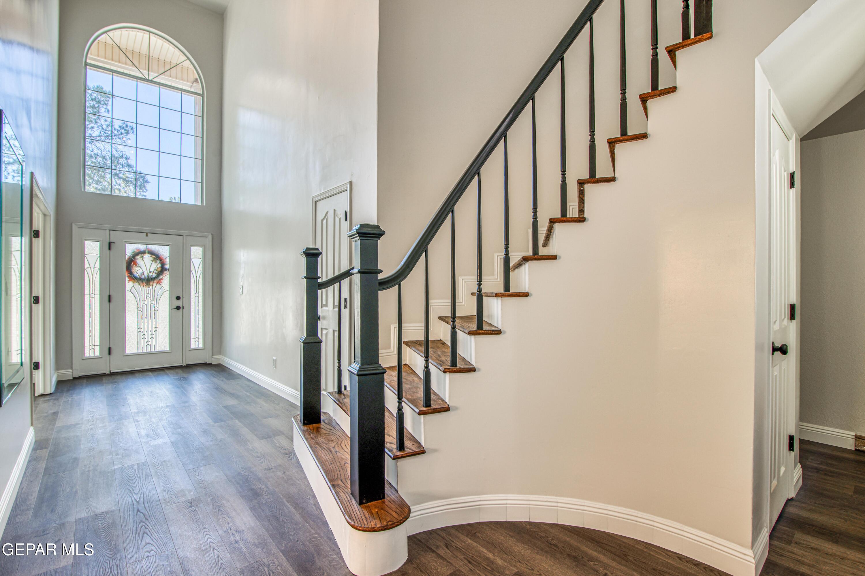 6620 Imperial Ridge Drive El Paso, TX 79912 - Photo 8 of 50 a view of an entryway with wooden floor and staircase