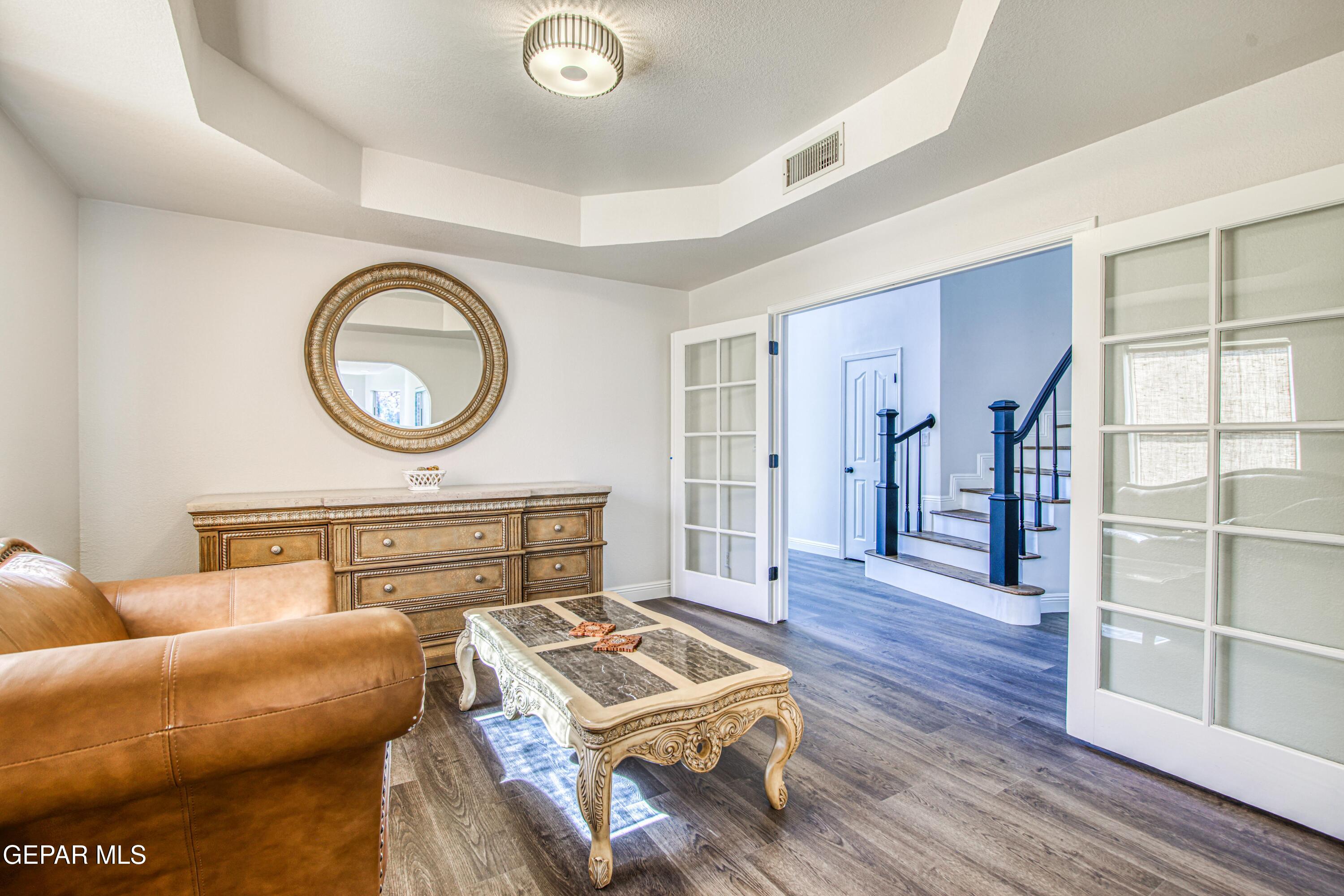 6620 Imperial Ridge Drive El Paso, TX 79912 - Photo 10 of 50 a living room with a couch and a stove with wooden floor