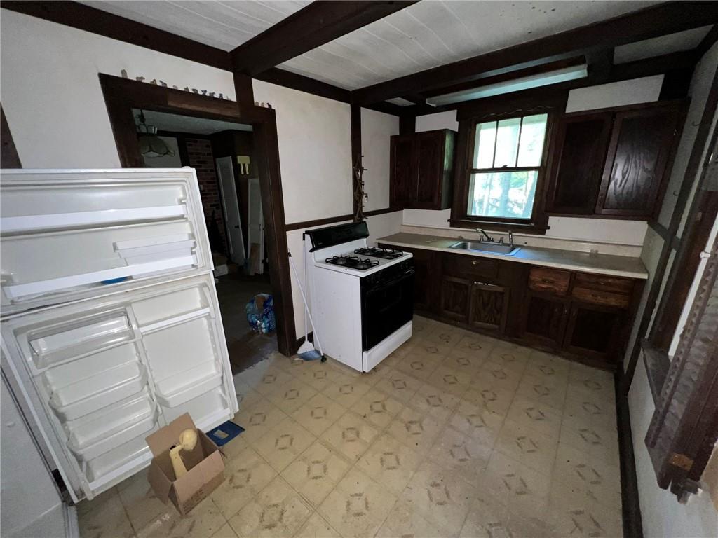 143 Coal Valley Road Clairton, PA 15025 - Photo 13 of 37 a kitchen with a stove and white cabinets
