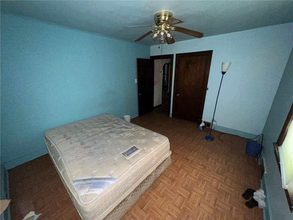 143 Coal Valley Road Clairton, PA 15025 - Photo 17 of 37 a bedroom with a bed and a chandelier