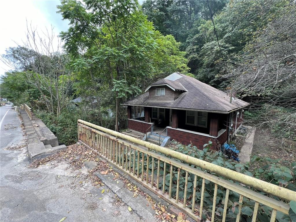 143 Coal Valley Road Clairton, PA 15025 - Photo 4 of 37 a front view of house with yard and trees in the background