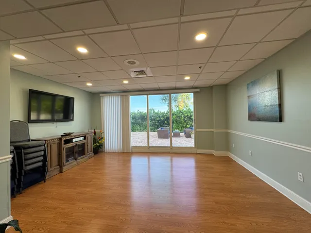 a view of a livingroom with furniture wooden floor and window