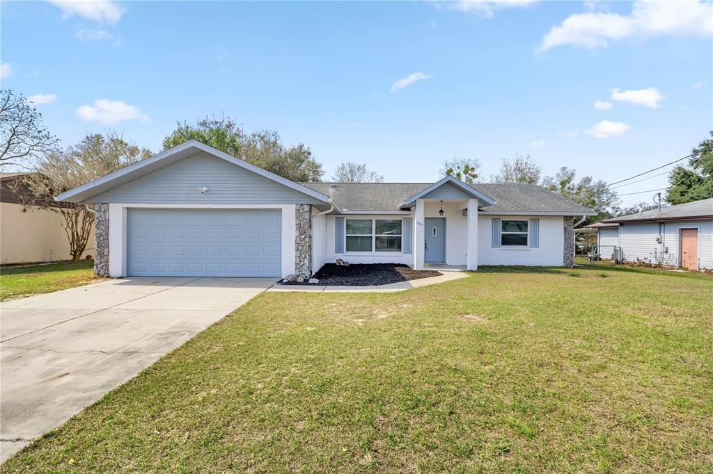 11862 Southeast 72nd Terrace Road Belleview, FL 34420 - Photo 1 of 1 a front view of a house with a yard and garage