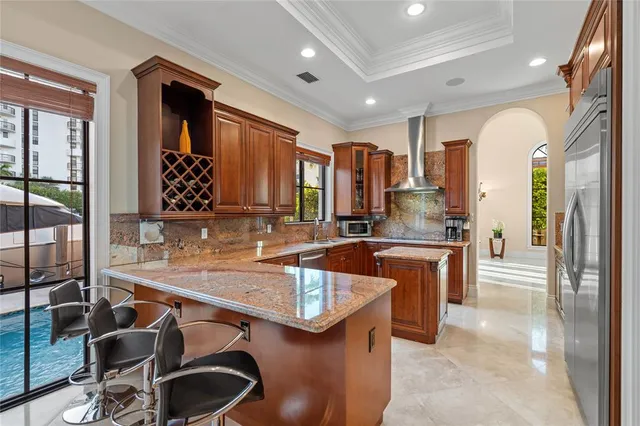 a kitchen with stainless steel appliances granite countertop a sink stove and refrigerator