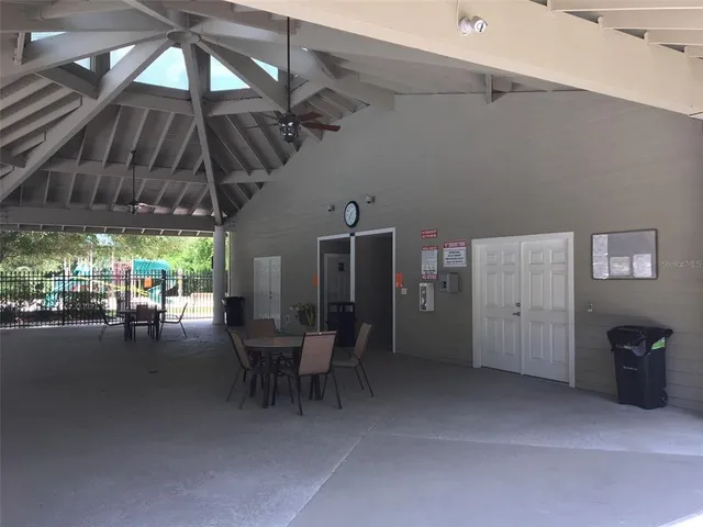 a view of a patio with table and chairs under an umbrella
