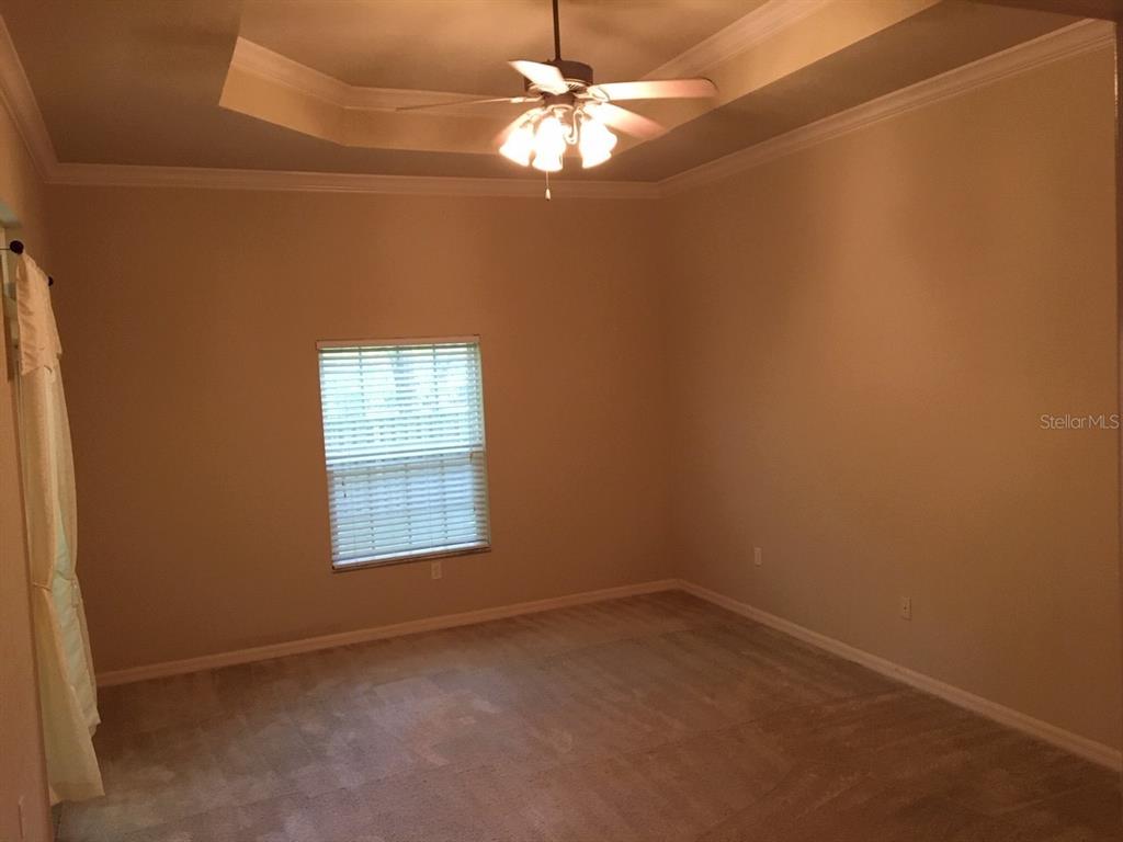 8559 Southwest 11th Road Gainesville, FL 32607 - Photo 17 of 19 an empty room with a window and a fan