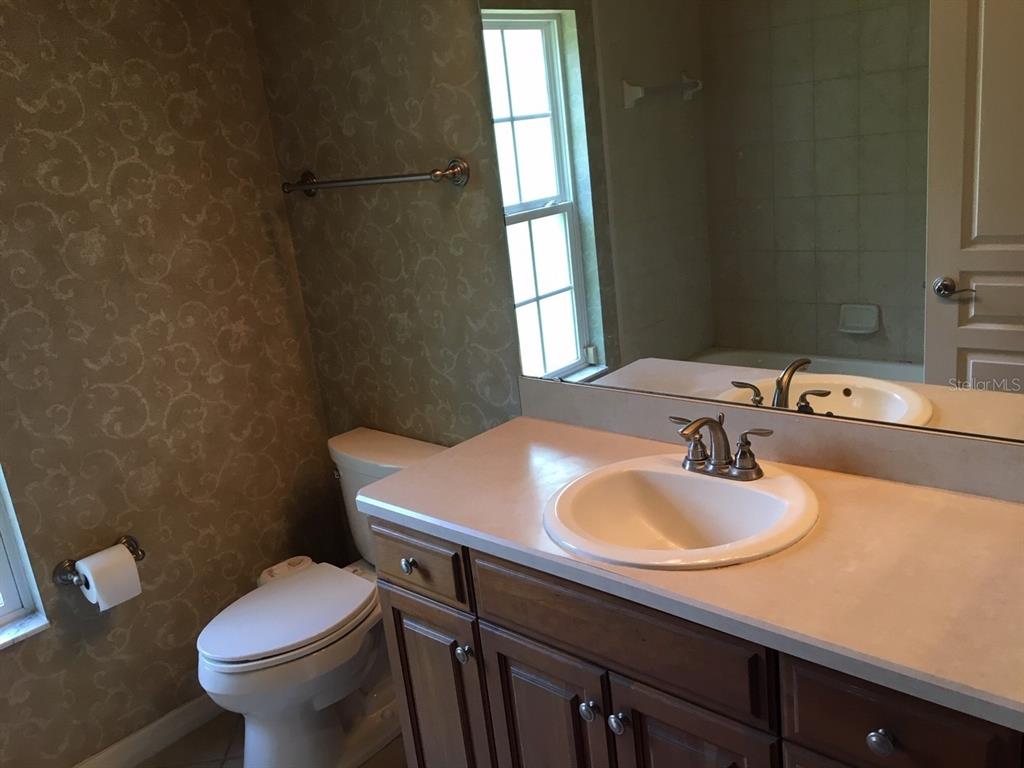 8559 Southwest 11th Road Gainesville, FL 32607 - Photo 5 of 19 a bathroom with a sink toilet vanity and mirror