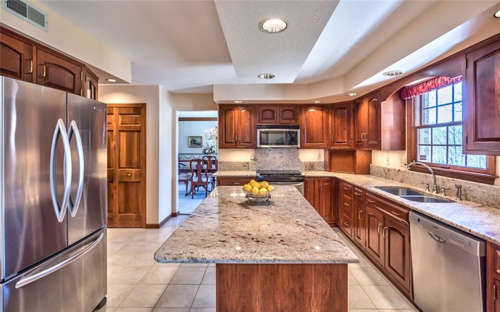 471 Pinkerton Road Wexford, PA 15090 - Photo 11 of 25 Beautifully Renovated Gourmet Granite & Stainless Center Island Kitchen, Island Seating, abundant Custom Cabinetry with Under Cabinet Lighting and Sleek Granite Backsplash