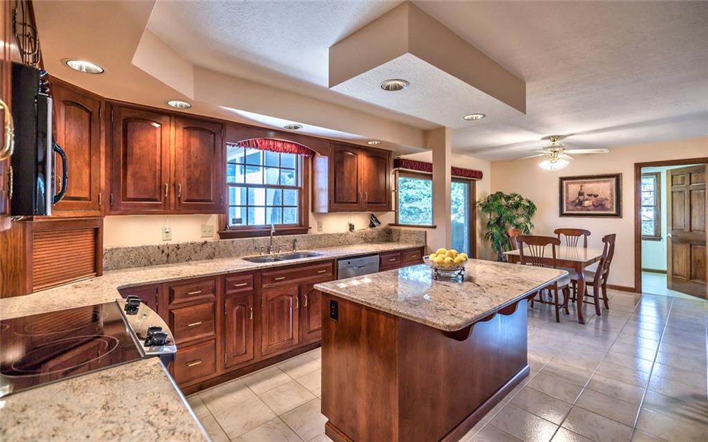 471 Pinkerton Road Wexford, PA 15090 - Photo 10 of 25 Beautifully Renovated Gourmet Granite & Stainless Center Island Kitchen, Island Seating, abundant Custom Cabinetry with Under Cabinet Lighting and Sleek Granite Backsplash