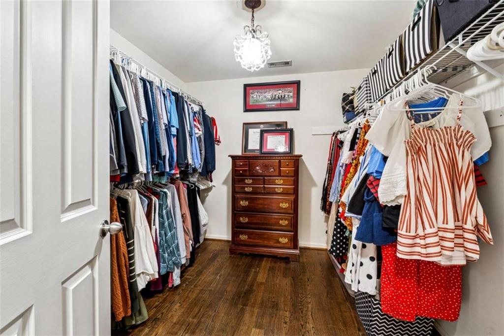 10296 Quadrant Court Alpharetta, GA 30022 - Photo 17 of 28 a view of walk in closet with clothes