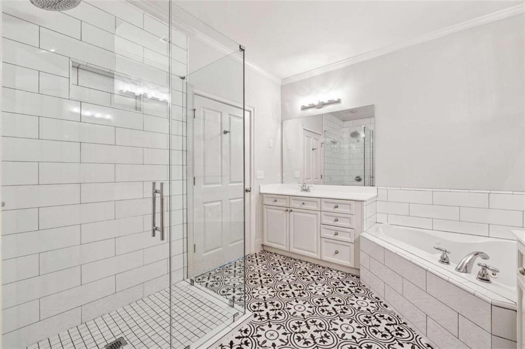 10296 Quadrant Court Alpharetta, GA 30022 - Photo 18 of 28 a bathroom with a shower a sink and a mirror