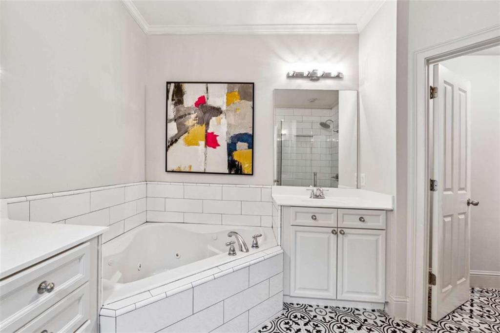 10296 Quadrant Court Alpharetta, GA 30022 - Photo 19 of 28 a bathroom with a tub a sink and mirror