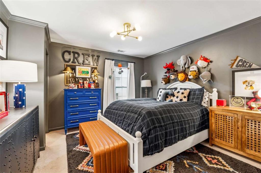 10296 Quadrant Court Alpharetta, GA 30022 - Photo 20 of 28 a bedroom with a bed and a chandelier