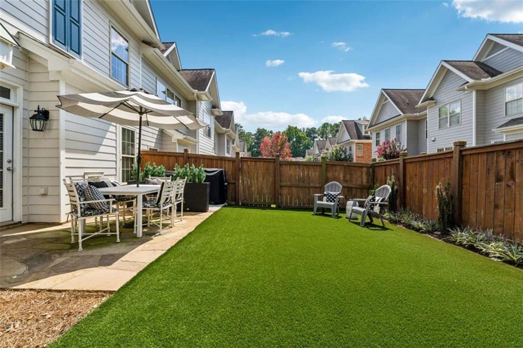 10296 Quadrant Court Alpharetta, GA 30022 - Photo 2 of 28 a view of a chair and table in backyard of the house