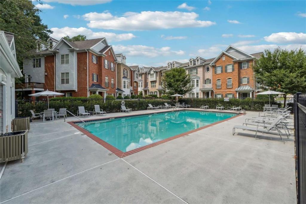 10296 Quadrant Court Alpharetta, GA 30022 - Photo 27 of 28 a view of a house with a swimming pool and a yard