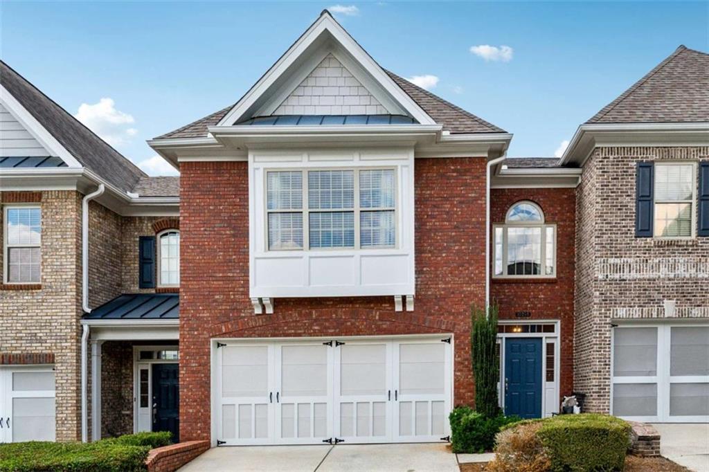 10296 Quadrant Court Alpharetta, GA 30022 - Photo 3 of 28 a front view of a house with a yard