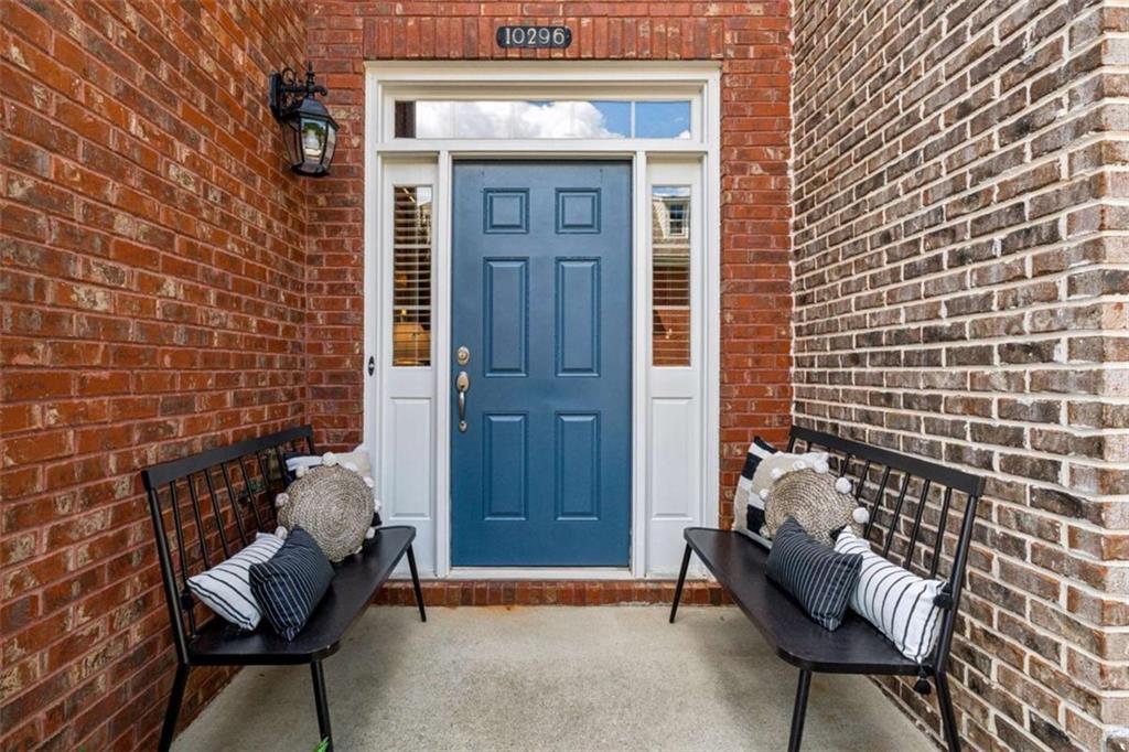 10296 Quadrant Court Alpharetta, GA 30022 - Photo 4 of 28 a view of a brick house with outdoor seating space