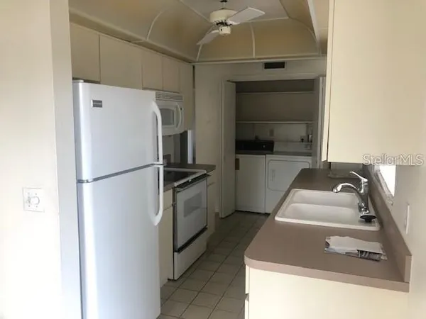 a kitchen with a refrigerator and a sink