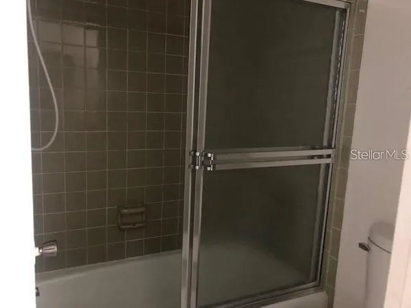 a bathroom with a glass door shower