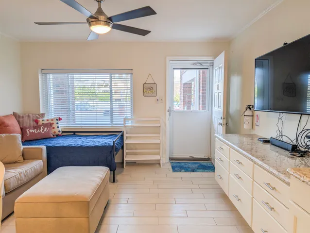 a spacious bedroom with a large bed and a flat screen tv