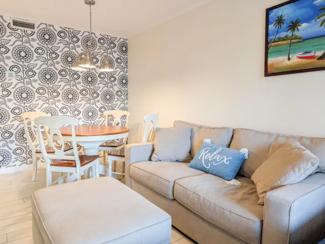 a living room with furniture and painting on the wall