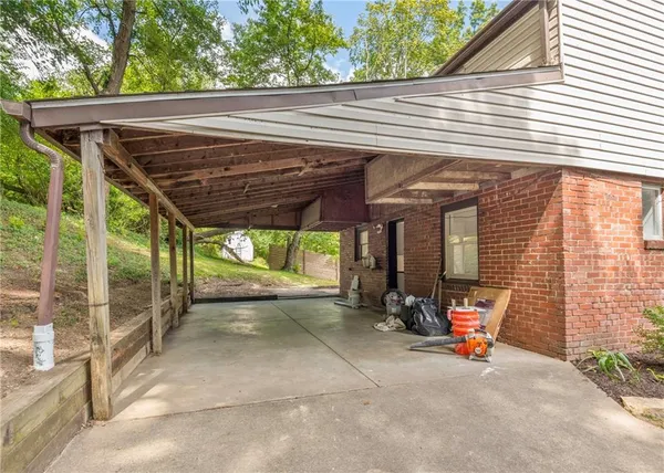a view of a house with backyard porch and sitting area