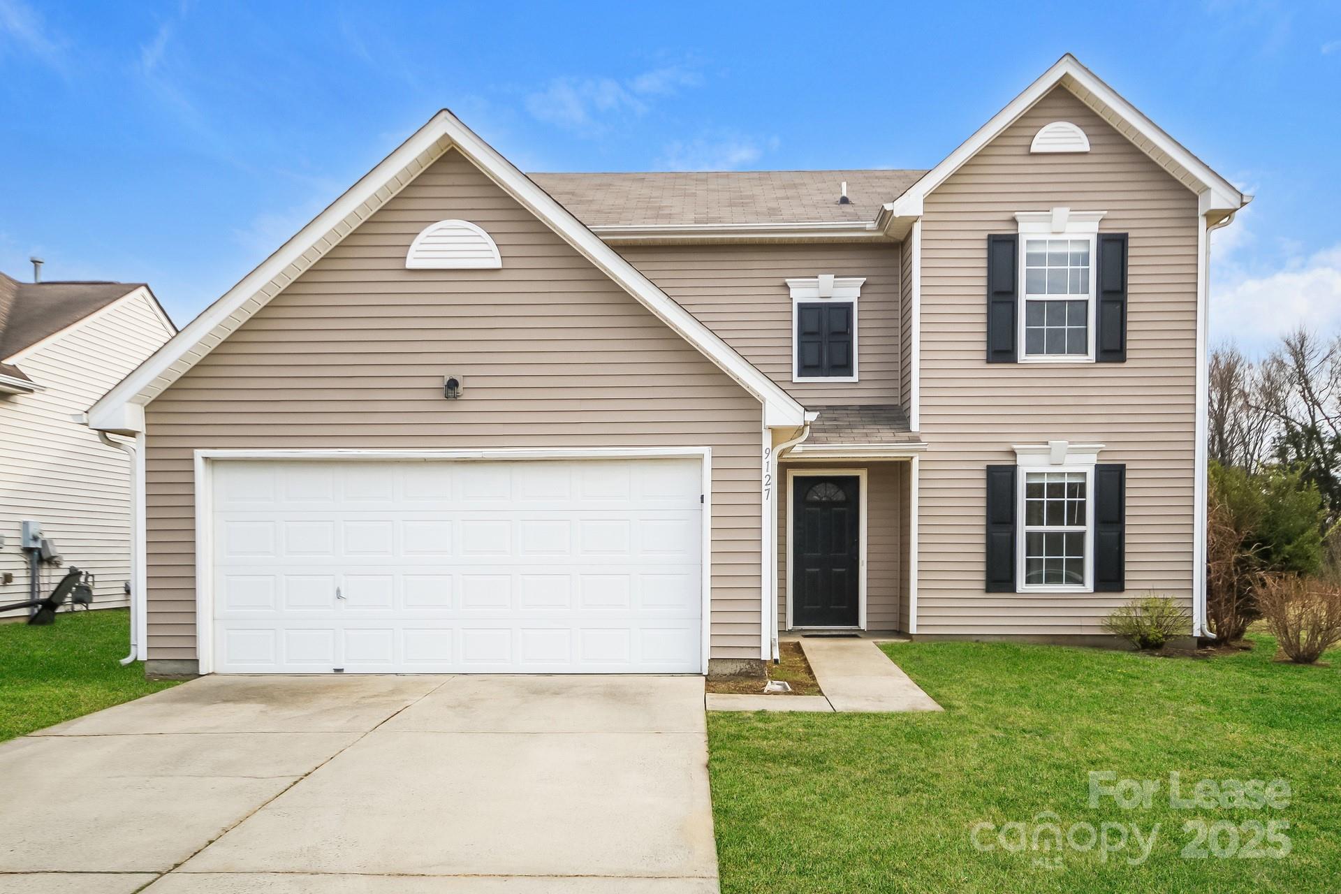a view of a yard in front view of a house