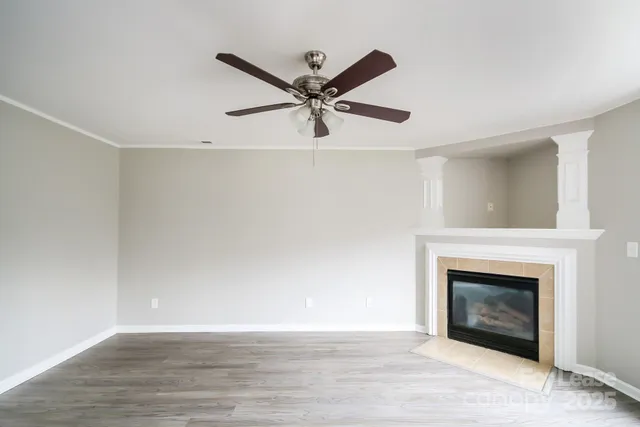 a view of a livingroom with a fireplace and a ceiling fan