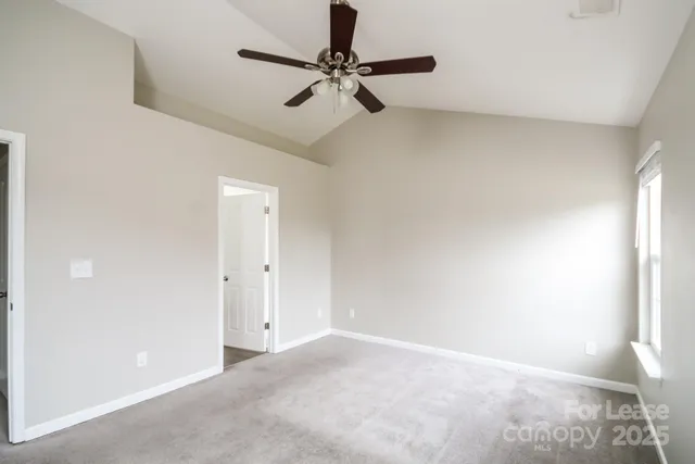 a view of a livingroom with a ceiling fan and window