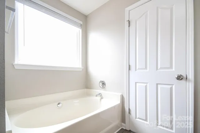 a white bath tub sitting next to a window