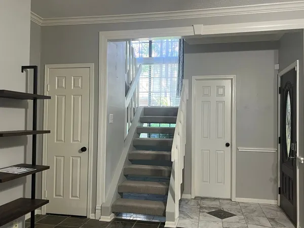 a view of a hallway with wooden floor and entryway