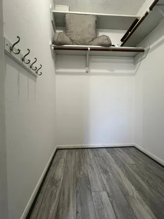 a view of a room with wooden floor